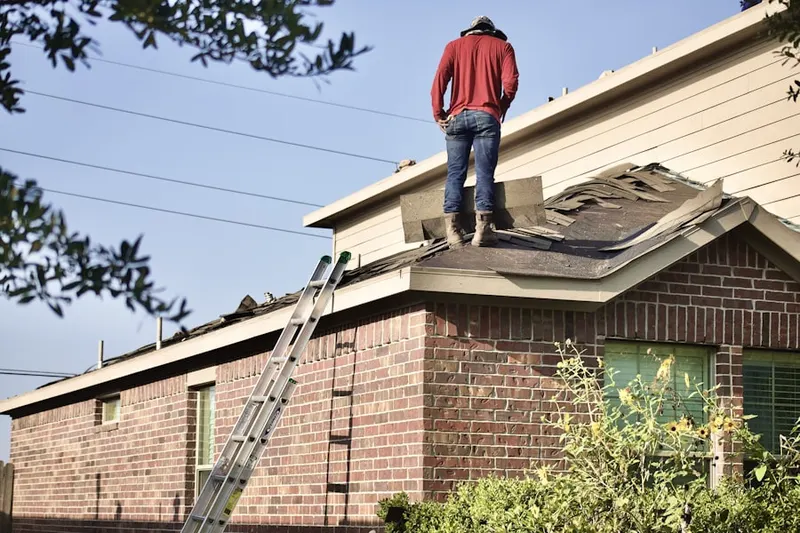 Professional roofer working on a residential roof in New York Mills